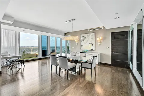 a dining room with furniture window and wooden floor