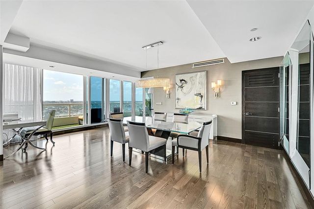 a dining room with furniture window and wooden floor