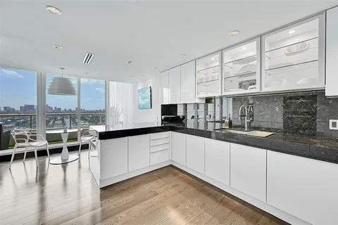 a kitchen with stainless steel appliances granite countertop a sink and cabinets