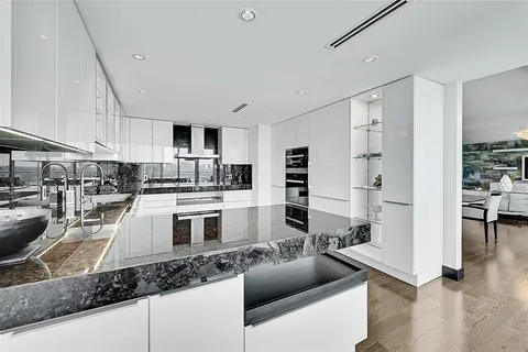 a kitchen with stainless steel appliances granite countertop a sink a stove and a refrigerator