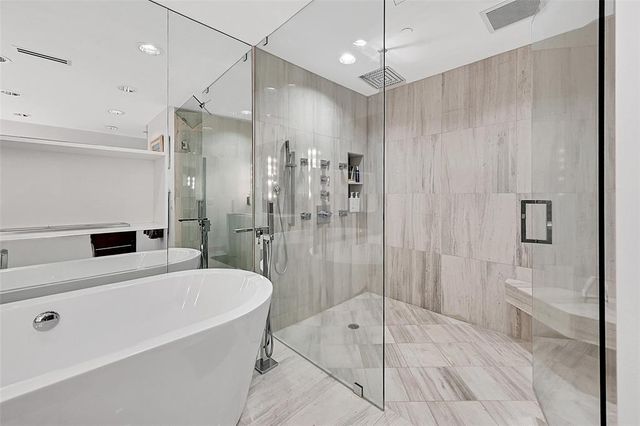 a bathroom with a tub a sink and a shower