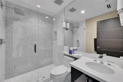a bathroom with a sink toilet and shower