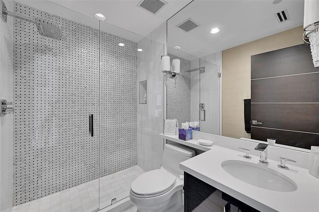 a bathroom with a sink toilet and shower
