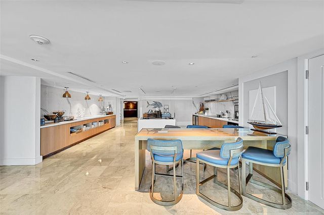 a kitchen with a table and chairs in it