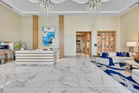 a bedroom with furniture and a chandelier