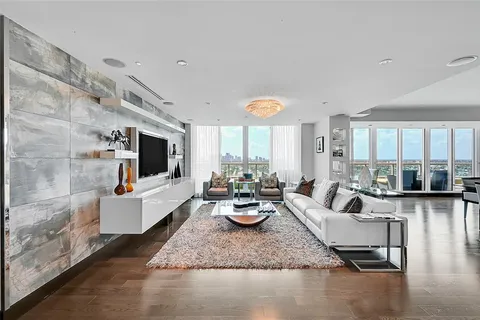 a living room with fireplace furniture and a flat screen tv