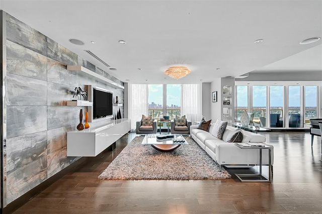 a living room with fireplace furniture and a flat screen tv