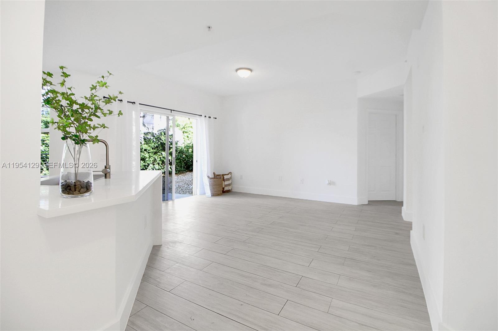 8930 Northeast 8th Avenue, Unit 901 Miami, FL 33138 - Photo 12 of 24 In the distance the sliding doors in the living are visible allowing access to patio and rock garden