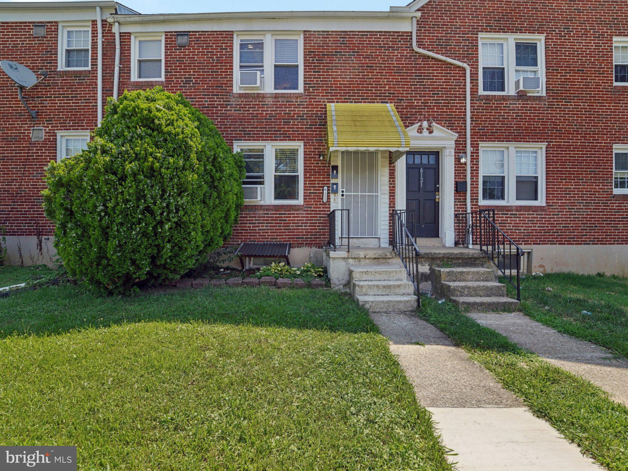 6123 MacBeth Drive Baltimore, MD 21239 - Photo 2 of 32 a front view of a house with garden