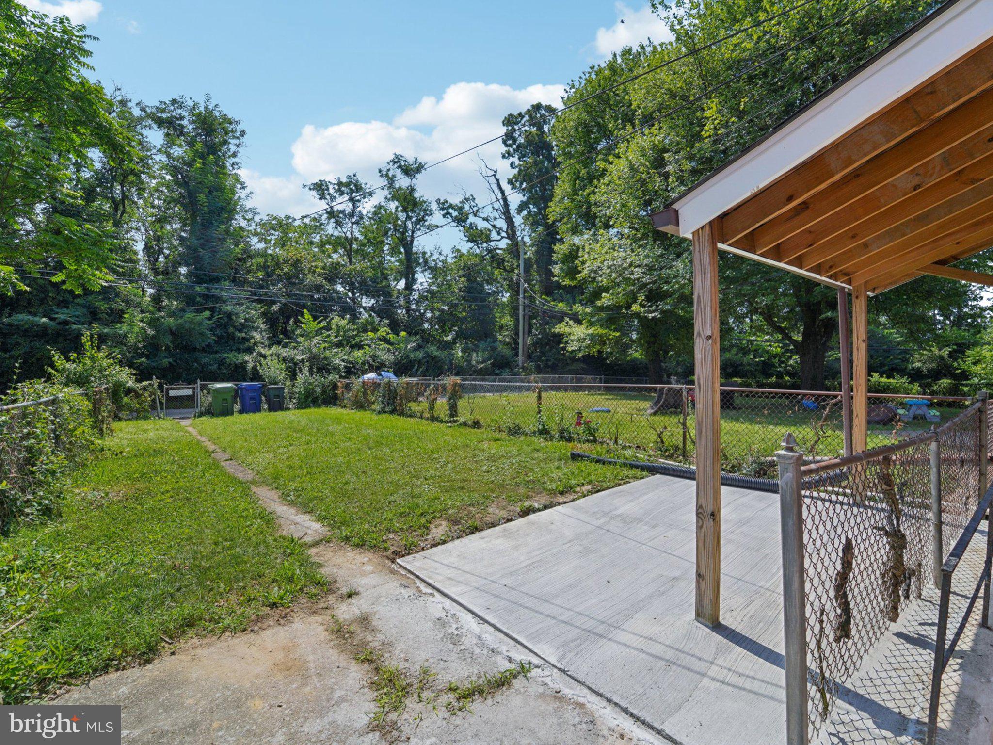 6123 MacBeth Drive Baltimore, MD 21239 - Photo 26 of 32 a view of a backyard with a garden and plants