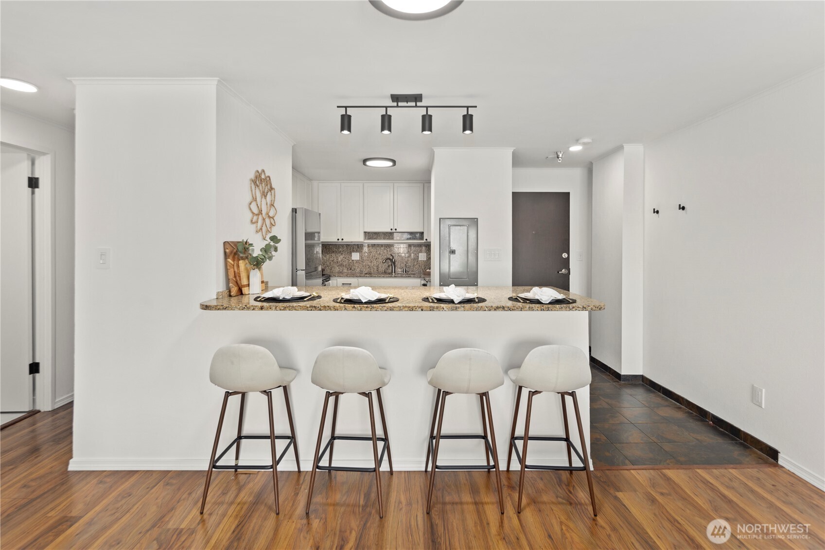 1300 University Street, Unit 2G Seattle, WA 98101 - Photo 12 of 28 a dining hall with stainless steel appliances kitchen island a table and chairs in it