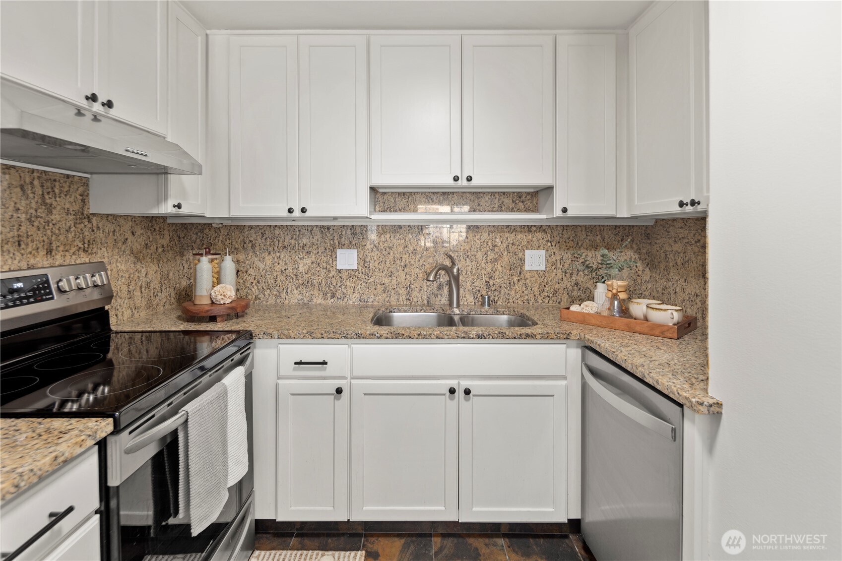 1300 University Street, Unit 2G Seattle, WA 98101 - Photo 15 of 28 a kitchen with stainless steel appliances granite countertop a sink stove and cabinets