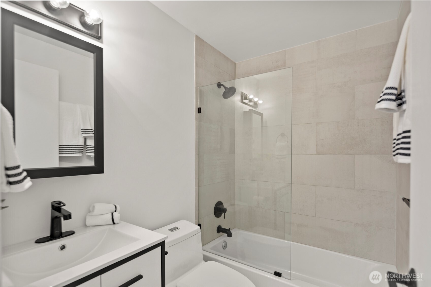 1300 University Street, Unit 2G Seattle, WA 98101 - Photo 16 of 28 a bathroom with a sink a toilet and shower