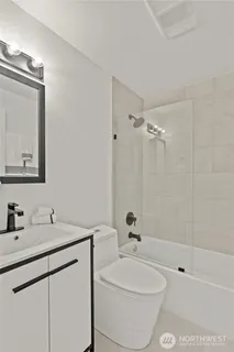 a bedroom with a bed and a potted plant on th table