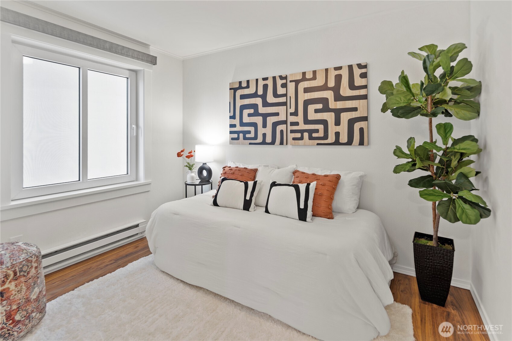 1300 University Street, Unit 2G Seattle, WA 98101 - Photo 19 of 28 a bedroom with a bed potted plant and a window