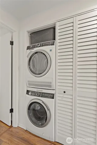 a kitchen with stainless steel appliances kitchen island granite countertop a dining table chairs and a refrigerator