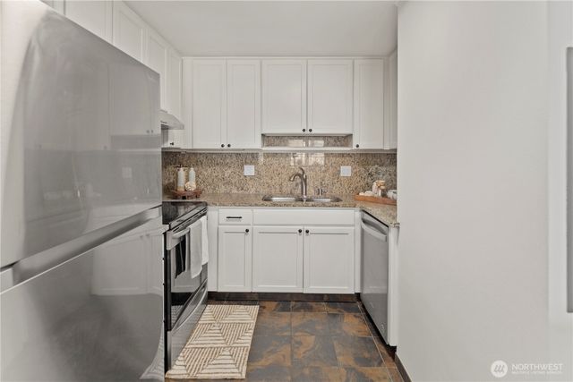 a dining hall with granite countertop white cabinets and a granite counter top