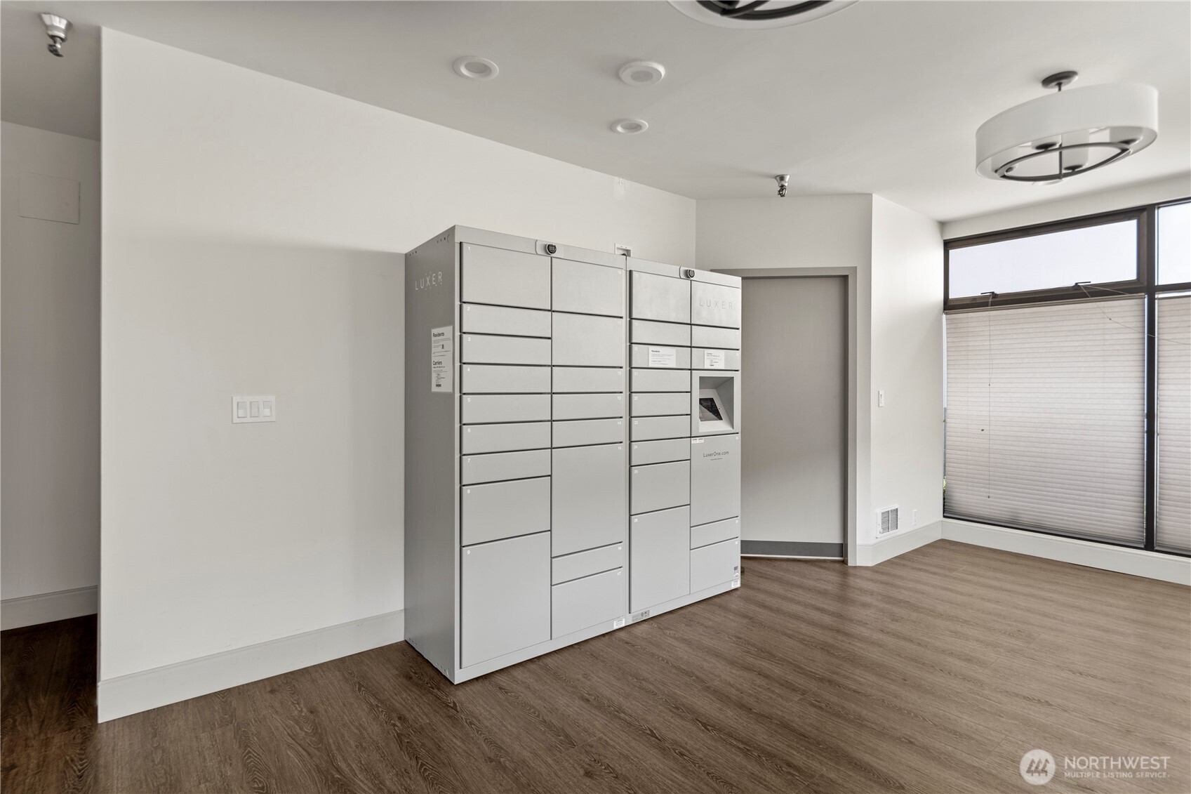 1300 University Street, Unit 2G Seattle, WA 98101 - Photo 28 of 28 an empty room with wooden floor cabinet and windows
