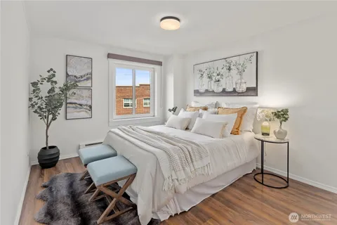 a bedroom with a bed and painting on the wall