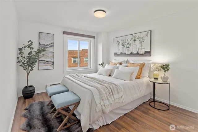 a bedroom with a bed and painting on the wall