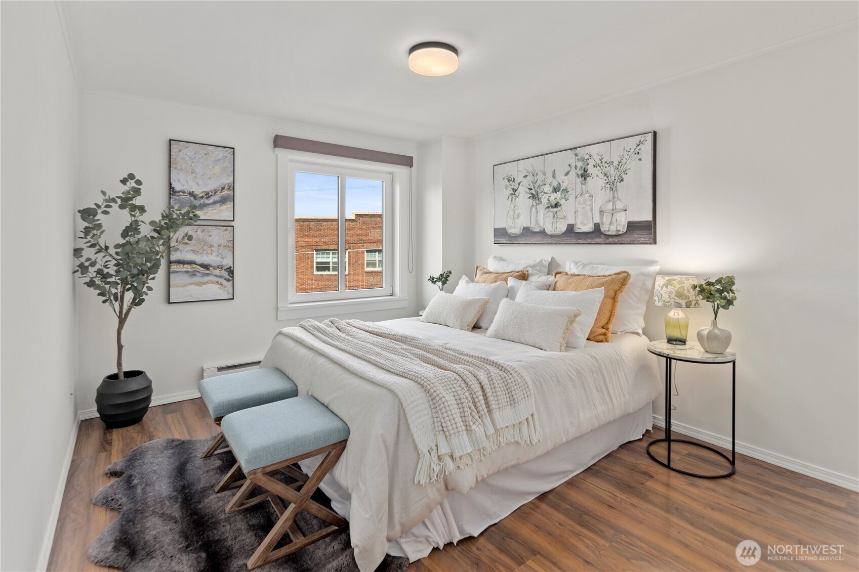 1300 University Street, Unit 2G Seattle, WA 98101 - Photo 8 of 28 a bedroom with a bed and a table