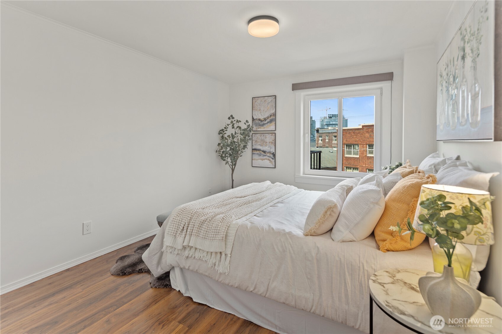 1300 University Street, Unit 2G Seattle, WA 98101 - Photo 9 of 28 a bedroom with a bed and painting on the wall