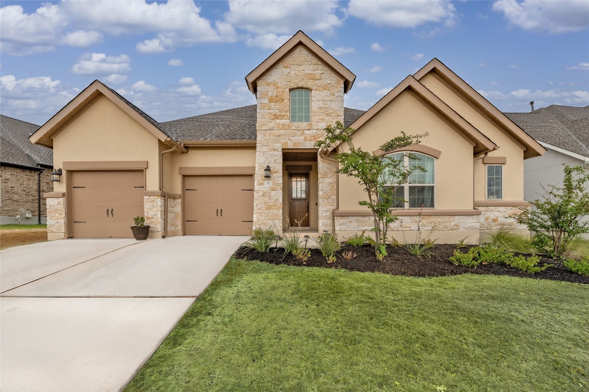 317 Encanto Place Austin, TX 78737 - Photo 1 of 1 a front view of a house with a yard and garage