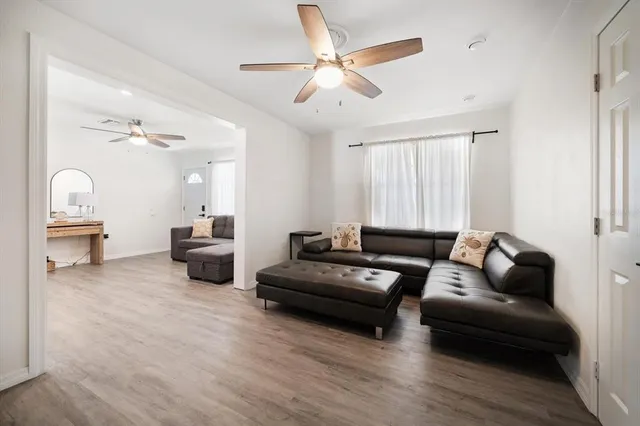 a bedroom with a large bed chandelier and a window