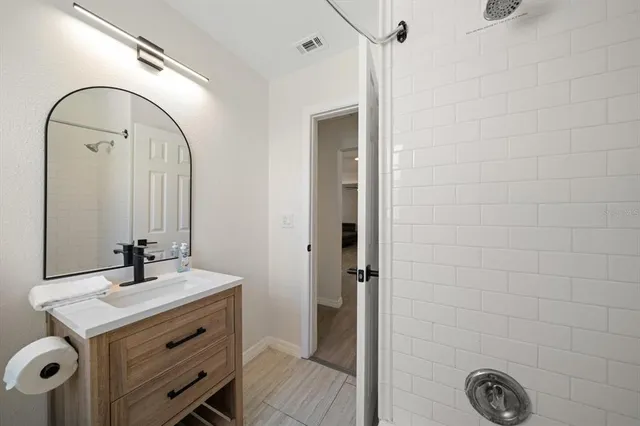 a bedroom with a bed and a ceiling fan