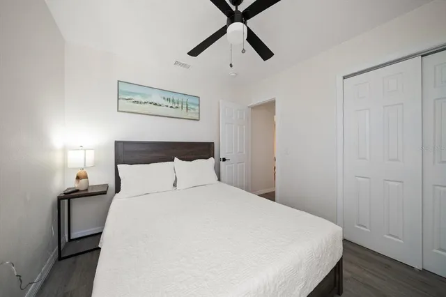 a bedroom with a bed and painting on the wall