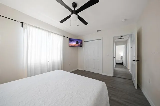 a spacious bedroom with a bed and a window