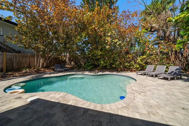 a backyard of a house with barbeque oven table and chairs