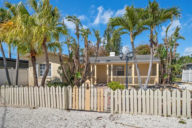 a view of a porch with a table and chairs