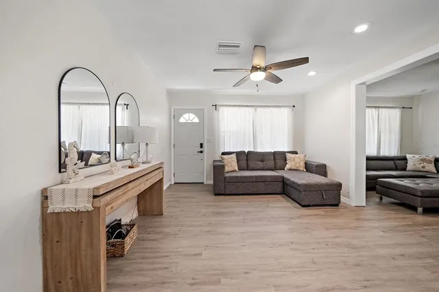 a living room with furniture and wooden floor