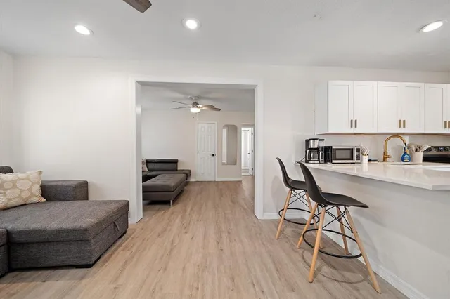 a kitchen with granite countertop white cabinets and stainless steel appliances