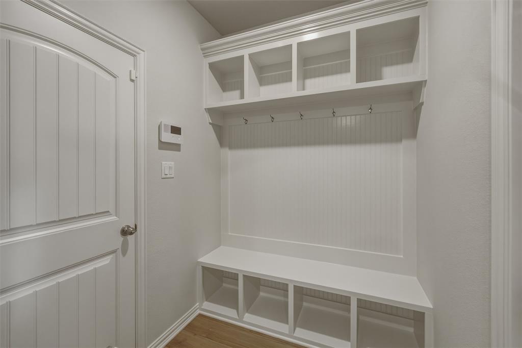 1325 Frio Drive Springtown, TX 76082 - Photo 18 of 24 Built-in mudroom station featuring upper cubbies, coat hooks, bench seating, and lower storage compartments