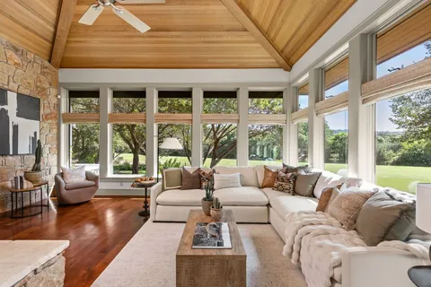 a living room with furniture and large windows