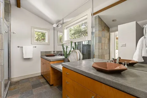 a kitchen with kitchen island granite countertop a sink appliances and cabinets