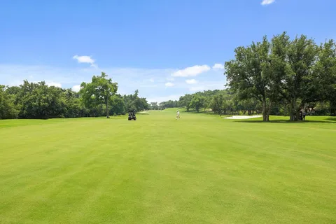 a view of yard with swimming pool and green space