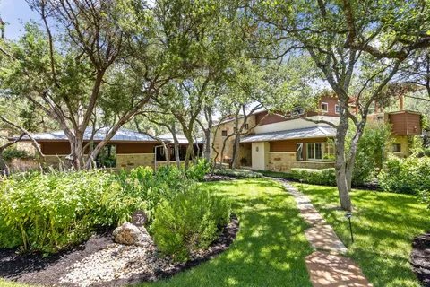 a front view of a house with a garden
