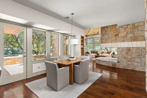 a kitchen with stainless steel appliances granite countertop a sink a stove and a wooden floors