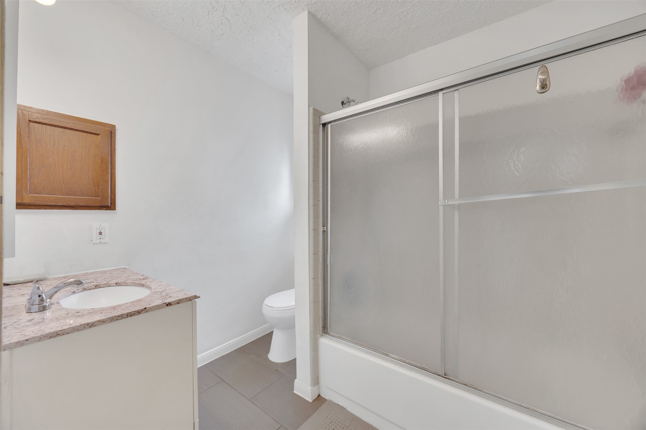 15619 Beechnut Street Houston, TX 77083 - Photo 19 of 29 Updated full bath with granite countertop, neutral tones, and plenty of space for daily routines.