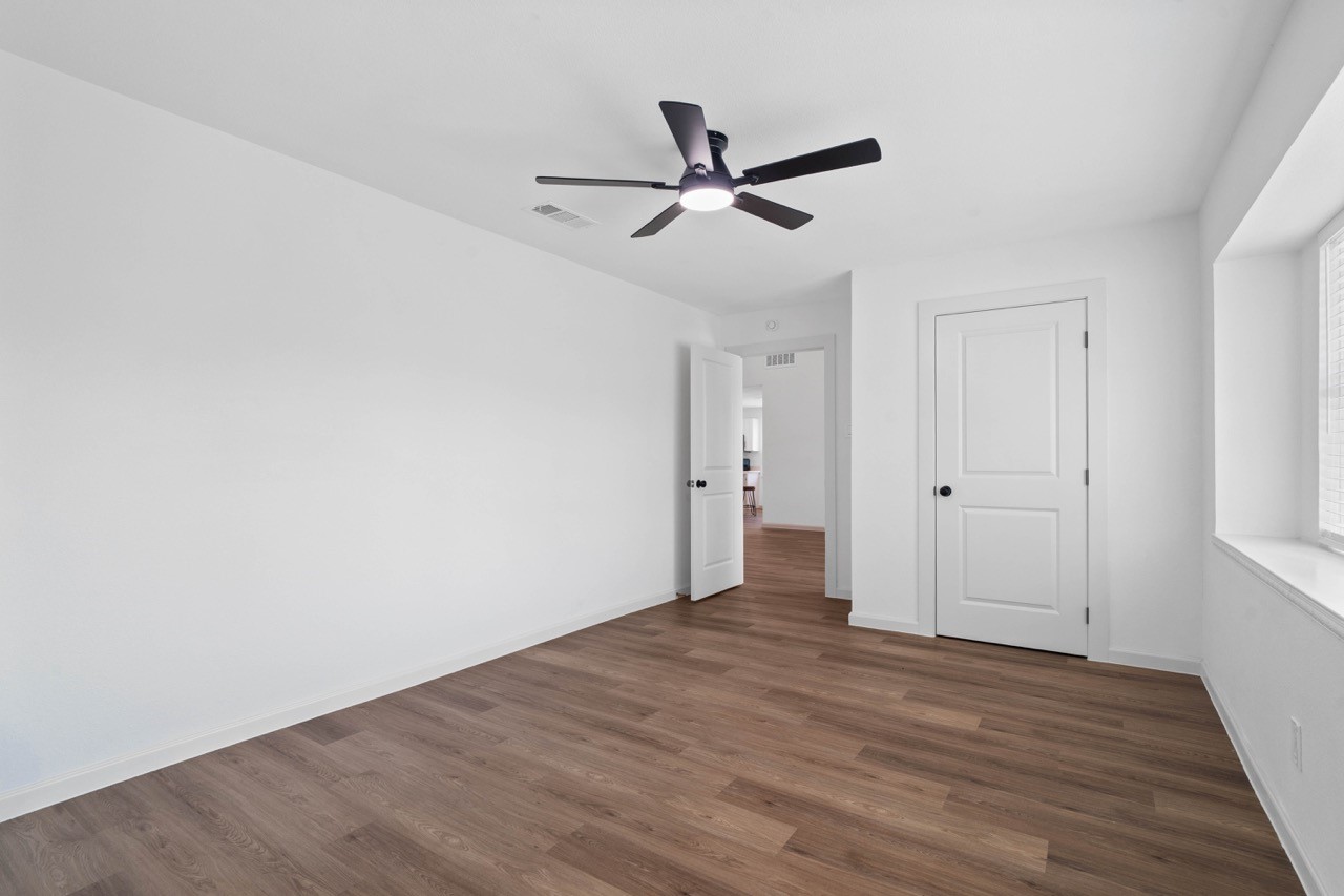 5326 Findlay Drive Pasadena, TX 77505 - Photo 40 of 50 Spacious secondary bedroom with luxury vinyl plank flooring, modern ceiling fan, and generous closet space.