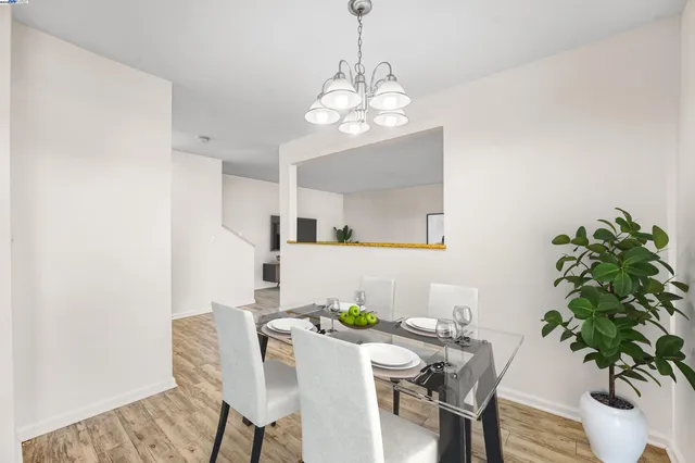 a view of a dining room with furniture and chandelier