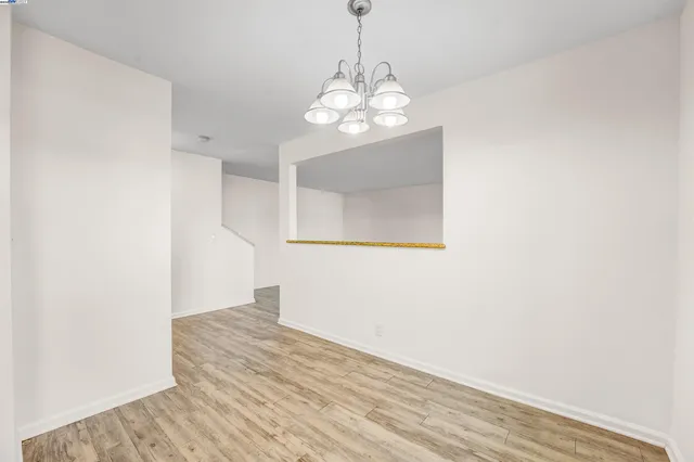 a view of wooden floor chandelier and closet in a room