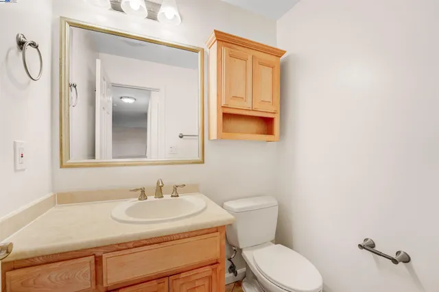 a bathroom with a sink toilet and a mirror