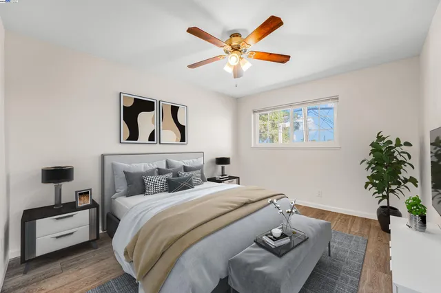 a bedroom with a large bed and a chandelier