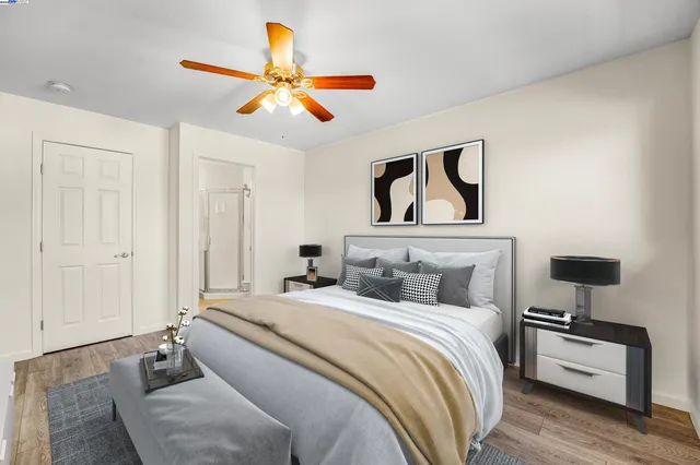 a bedroom with a bed and a painting on the wall