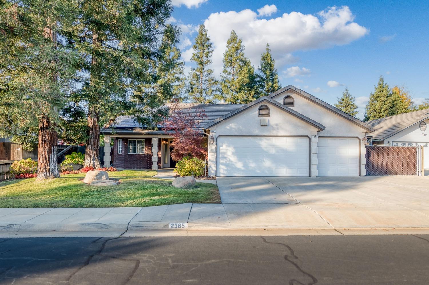 2365 Fallbrook Avenue Clovis, CA 93611 - Photo 1 of 42 a front view of a house with a yard and garage