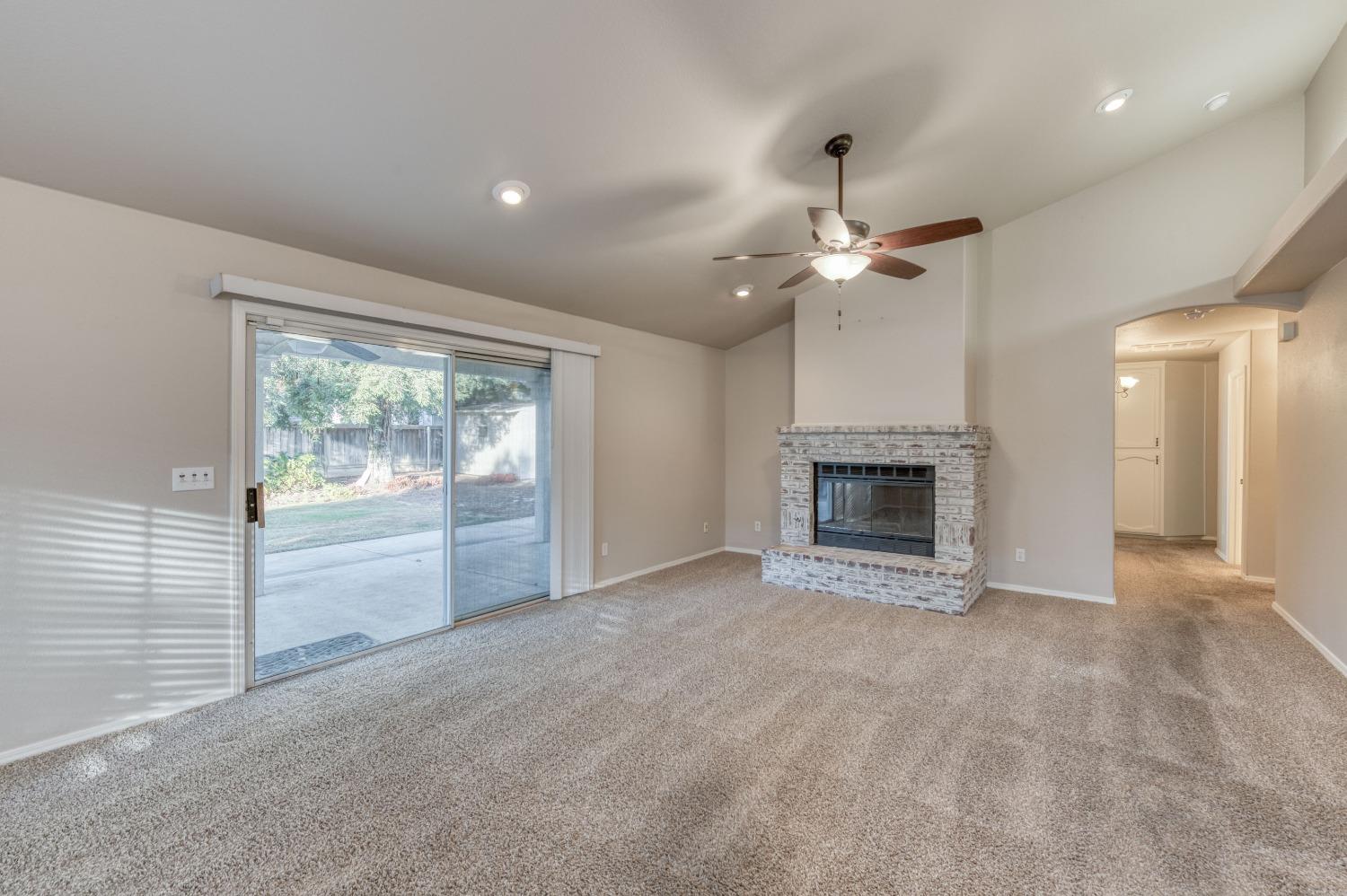 2365 Fallbrook Avenue Clovis, CA 93611 - Photo 11 of 42 a view of an empty room with a fireplace and a window